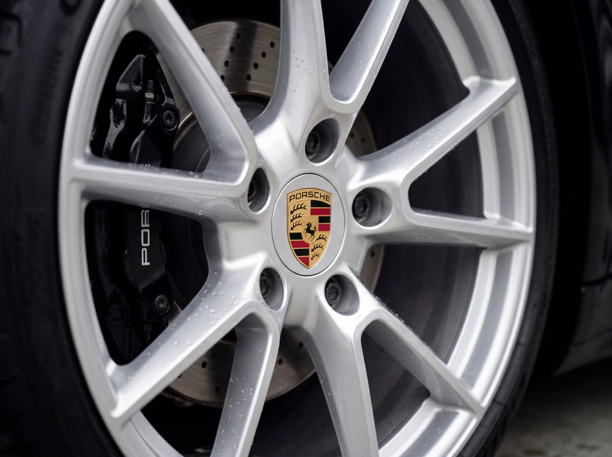 Saubere Porsche Alufelge mit polierten Speichen und zentralem Porsche Wappen nach Detailing-Reinigung ohne Bremsstaub oder Reiniger-Rückstände