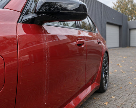 Detailing1 Sécher sa voiture — l'eau qui coule du rétro laisse des taches de calcaire sur la porte d'une BMW M5 rouge